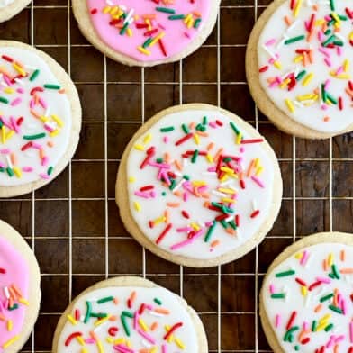 A closeup view of homemade sugar cookies frosted with the best sugar cookie icing in vibrant pink and bright white