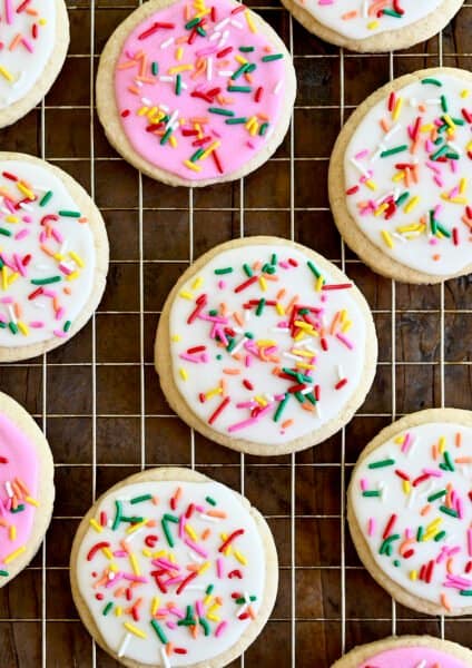 A closeup view of homemade sugar cookies frosted with the best sugar cookie icing in vibrant pink and bright white
