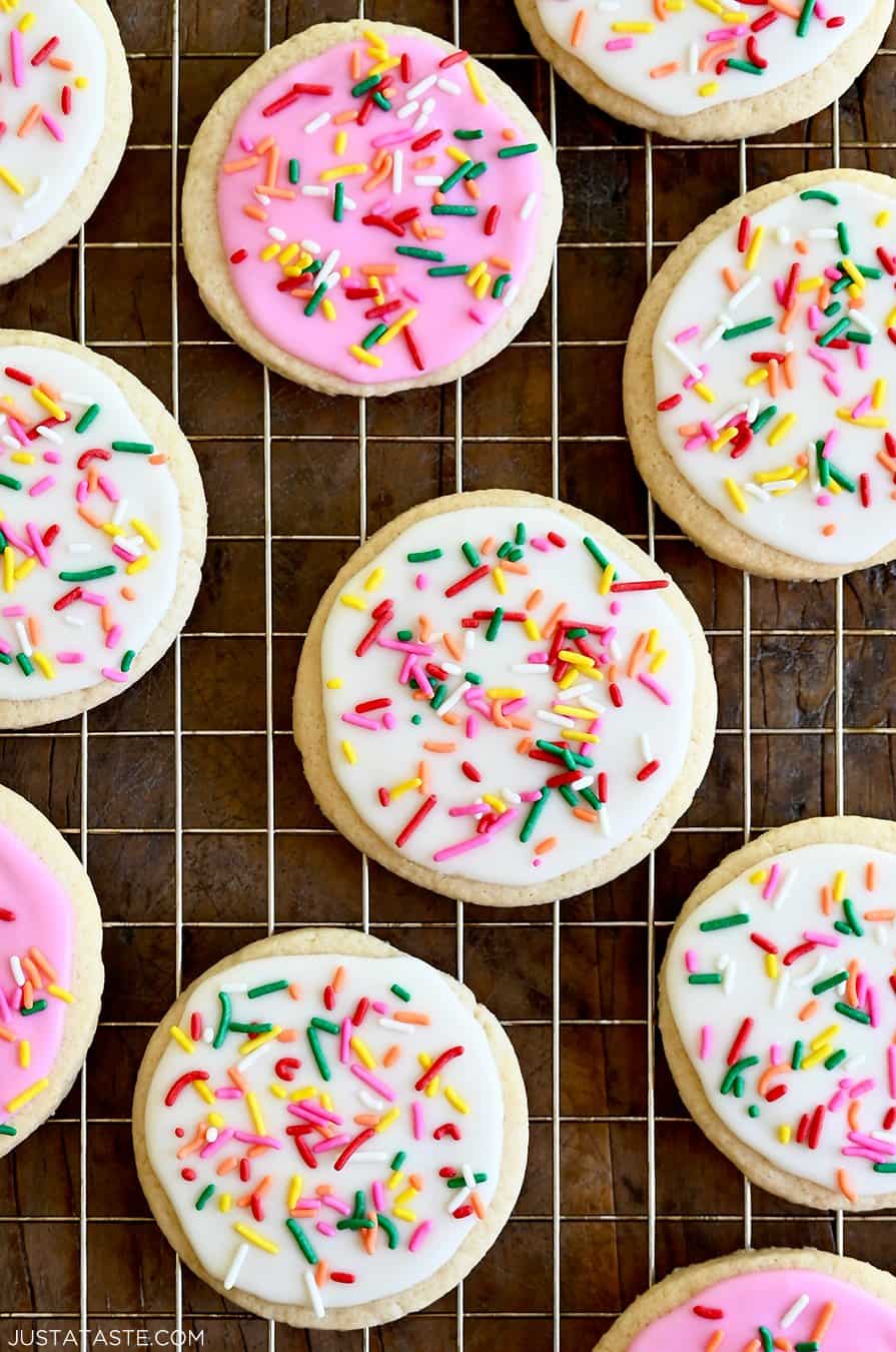 A closeup view of homemade sugar cookies frosted with the best sugar cookie icing in vibrant pink and bright white 