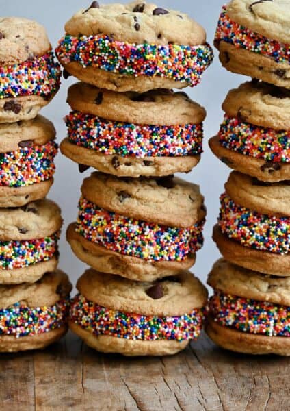 Cookie ice cream sandwiches with vanilla ice cream and rainbow sprinkles.