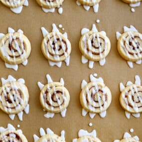 A top-down view of Cinnamon Roll Cookies drizzled with icing