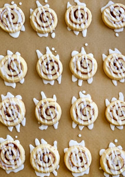 A top-down view of Cinnamon Roll Cookies drizzled with icing
