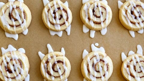 A top-down view of Cinnamon Roll Cookies drizzled with icing