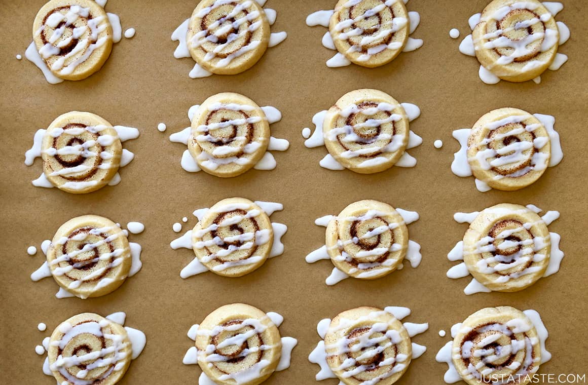 The best cinnamon roll cookies with icing on brown parchment paper