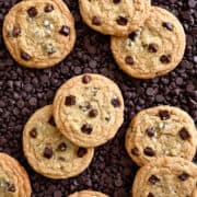 A top-down view of No-Chill Chocolate Chip Cookies atop a bed of chocolate chips.