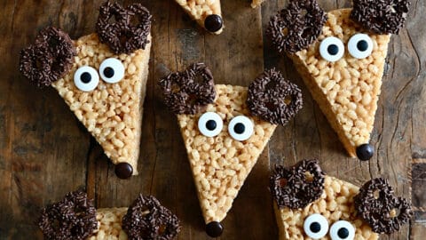 A top-down view of adorable Reindeer Rice Krispies Treats with candy eyes and chocolate-covered pretzels for antlers