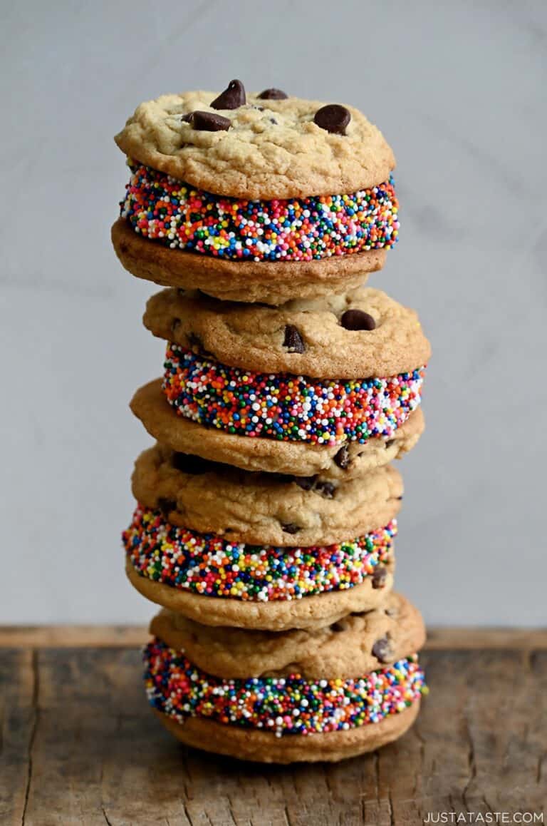 Vanilla ice cream cookie sandwiches rolled in sprinkles and stacked four high.