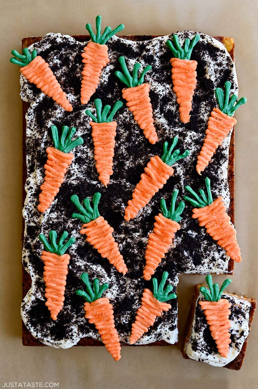 A top-down view Carrot Sheet Cake with Cream Cheese Frosting, Oreo dirt and candy melt carrots