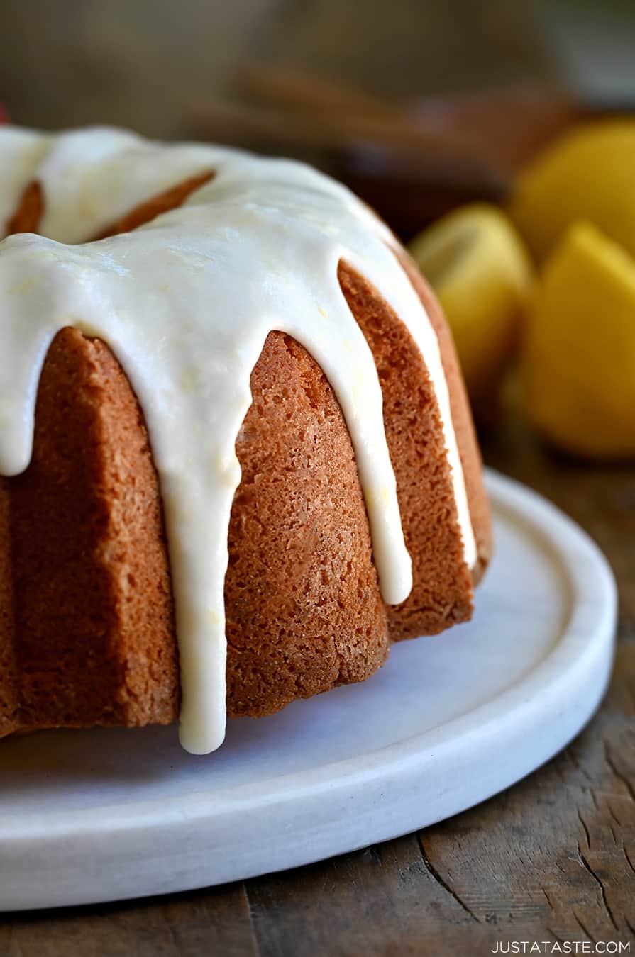 A closeup view of a pound cake topped with lemon glaze