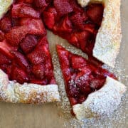 A top-down view of a strawberry galette made with puff pastry.