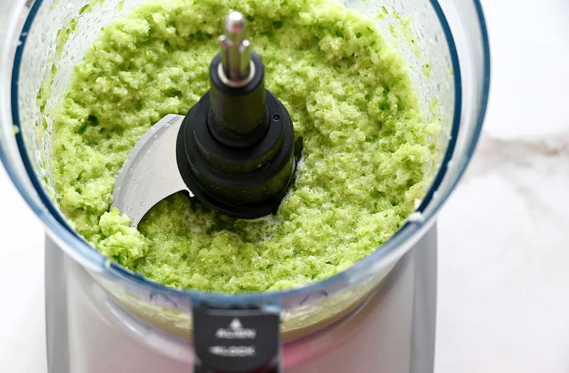 A food processor bowl containing sofrito