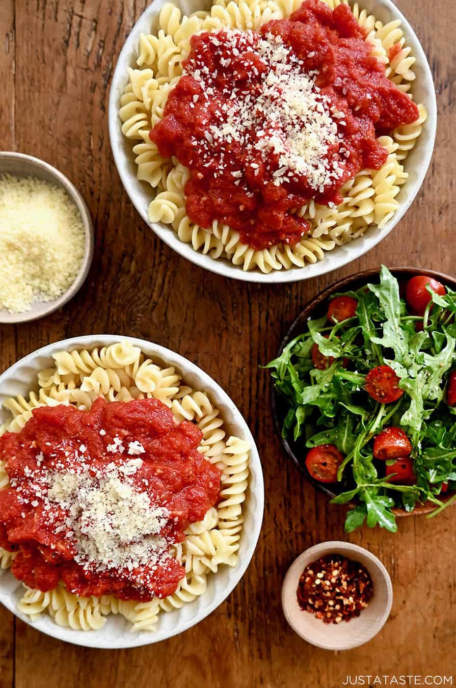 Two bowls containing quick homemade marinara sauce atop rotini pasta.