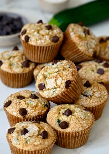 Moist zucchini muffins studded with chocolate chips and topped with sanding sugar.