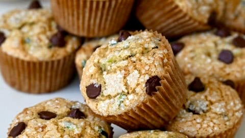 Moist zucchini muffins studded with chocolate chips and topped with sanding sugar.