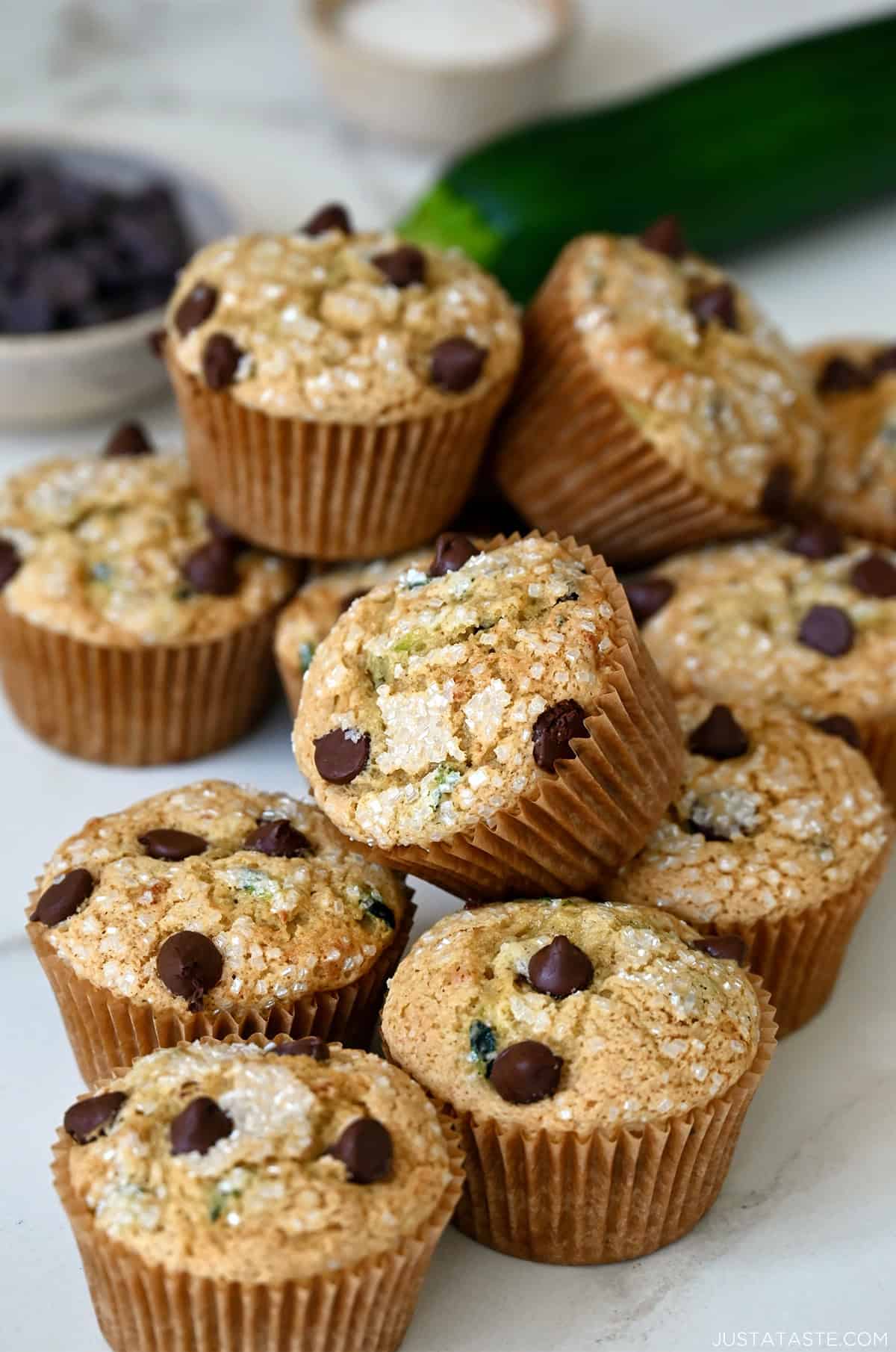 Moist zucchini muffins studded with chocolate chips and topped with sanding sugar.
