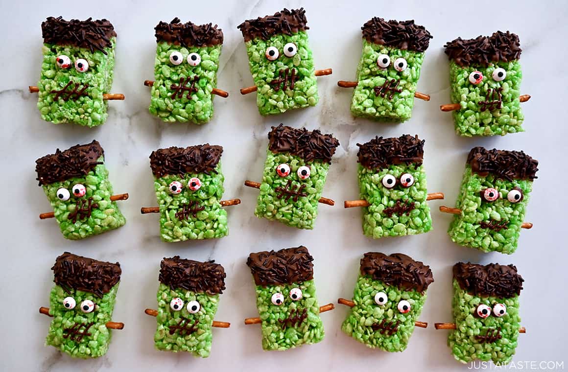 Frankenstein marshmallow treats lined up on a white marble background