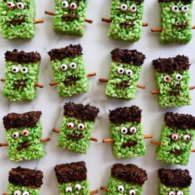 A top down view of Frankenstein cereal treats on white marble