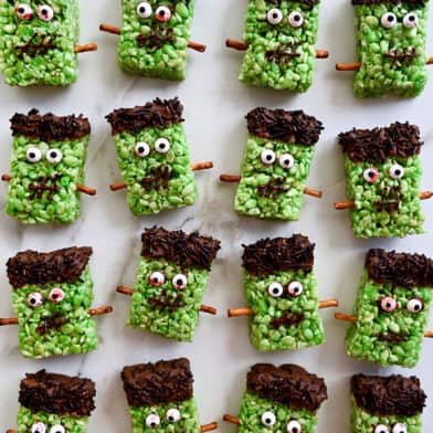 A top down view of Frankenstein cereal treats on white marble