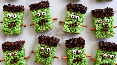 A top down view of Frankenstein cereal treats on white marble