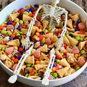 Easy Halloween snack mix with Chex cereal, pecans, candy corn, mini pretzels and M&Ms in a large serving bowl.