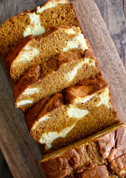 Pumpkin bread swirled with a cheesecake-like filling that's been cut into thick slices.