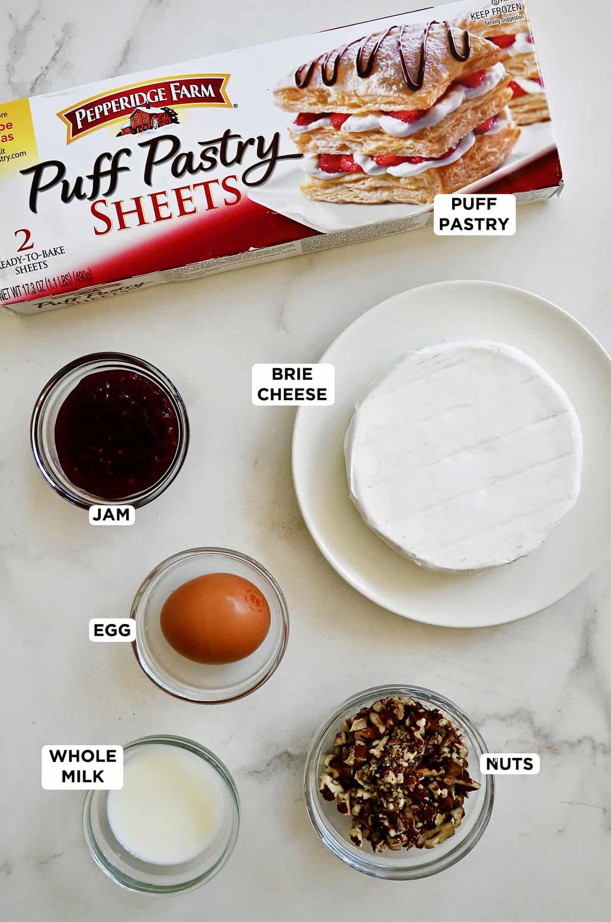 Ingredients to make puff pastry Brie bites with jam and toasted walnuts.