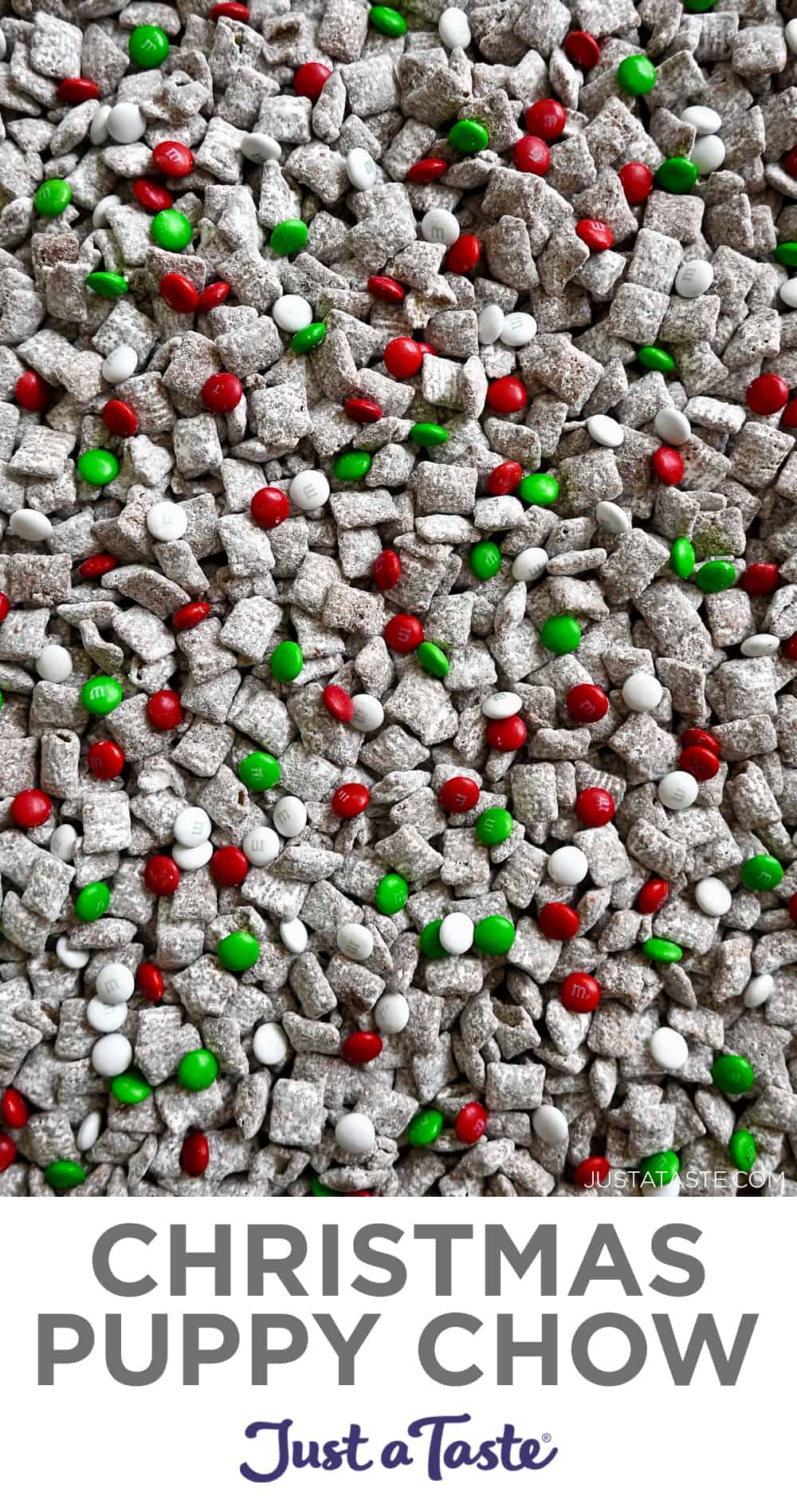 A top-down view of Christmas Puppy Chow featuring red, green and white M&Ms.