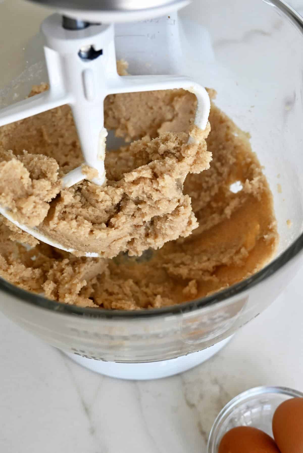 Creamed granulated and light brown sugars with butter in the bowl of a stand mixer with the paddle attachment.