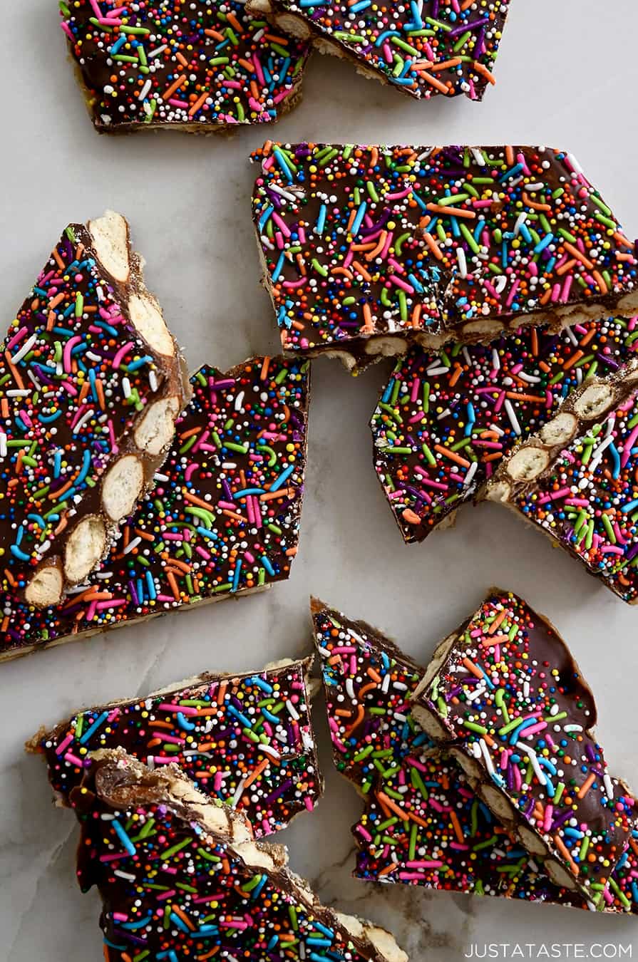 A top down view of pretzel bark broken into pieces on a white marble background