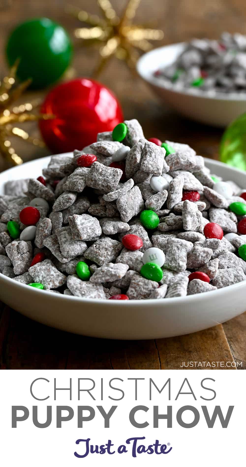 A white serving bowl containing muddy buddies with red, white and green M&Ms.