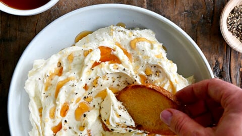 A top-down view of whipped Brie cheese in a bowl with toast