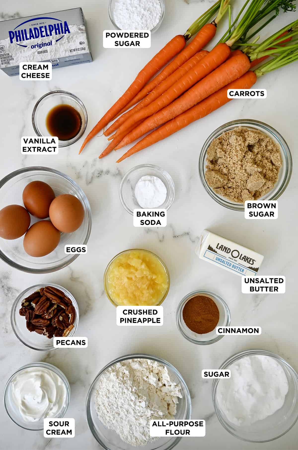 Ingredients to make a carrot cake sheet cake with cream cheese frosting.