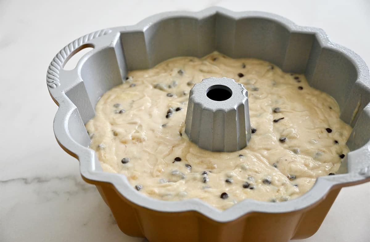 Banana cake batter studded with mini chocolate chips in a bundt pan.
