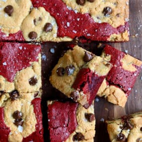 Sliced red velvet brookies studded with chocolate chips and sprinkled with large-flake sea salt.