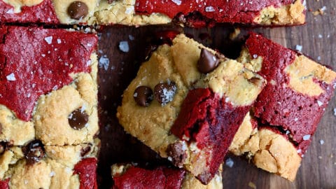 Sliced red velvet brookies studded with chocolate chips and sprinkled with large-flake sea salt.