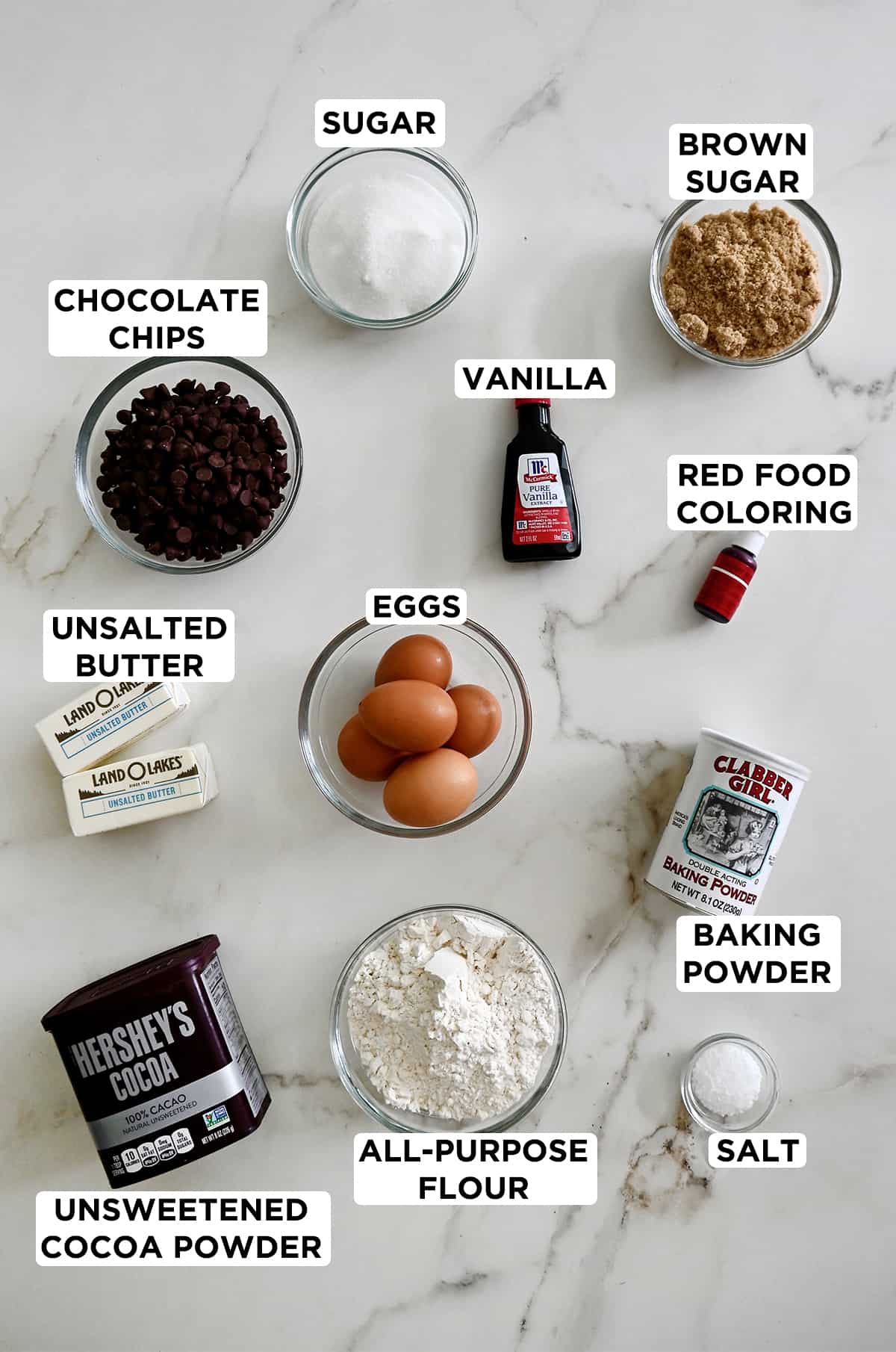 A top-down view of all the ingredients needed to make red velvet brookies, each of which are labeled.  
