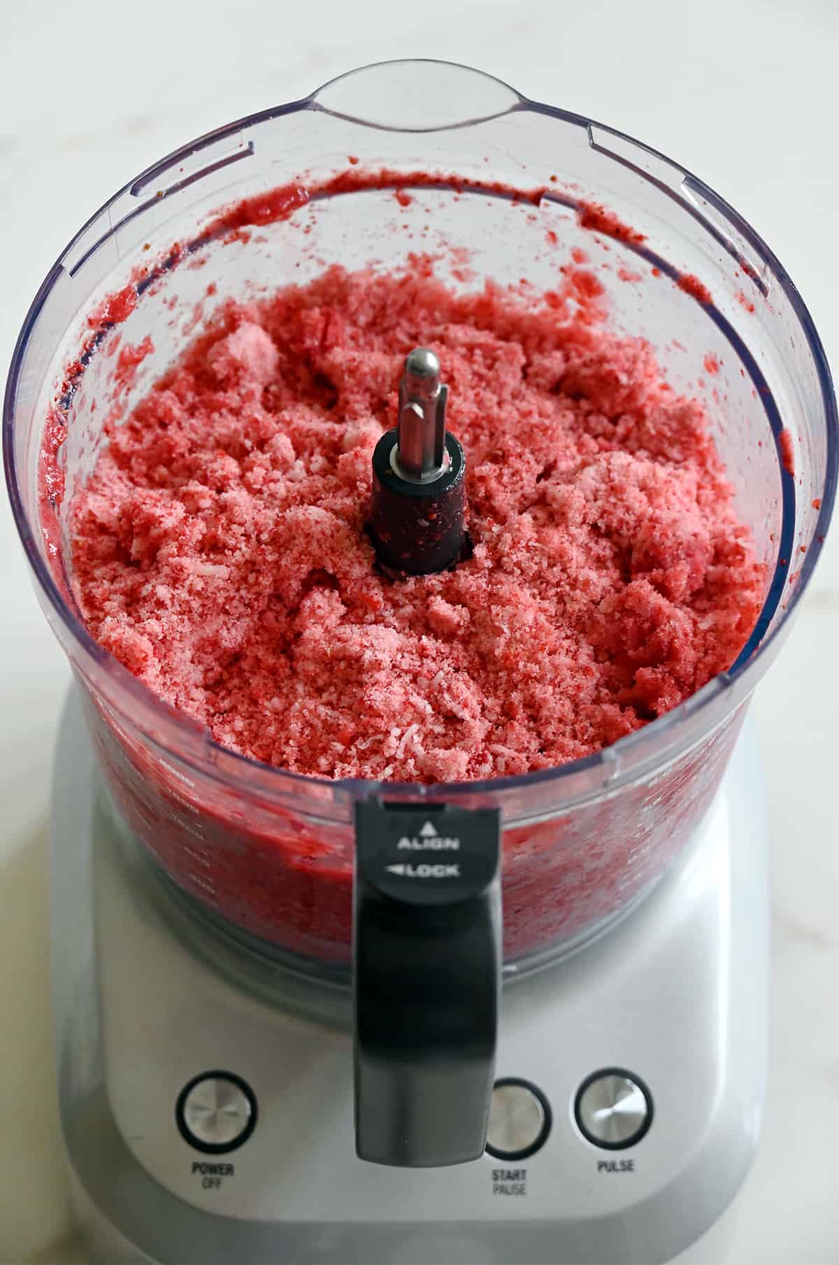 A food processor containing strawberry shaved ice