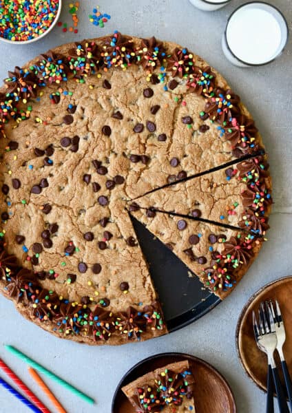 A top-down view of a Chocolate Chip Cookie Cake with chocolate frosting and rainbow sprinkles.