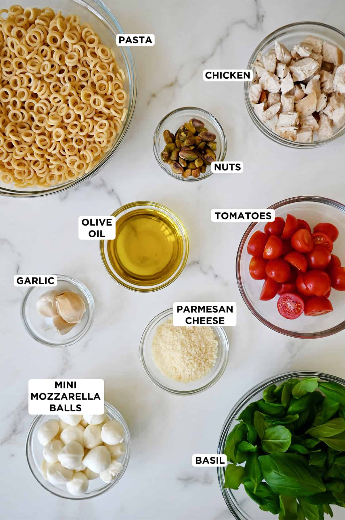 Pesto pasta ingredients in prep bowls.