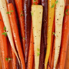 Baked carrots dressed with honey and olive oil and topped with fresh thyme leaves.