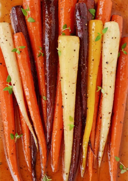 Baked carrots dressed with honey and olive oil and topped with fresh thyme leaves.