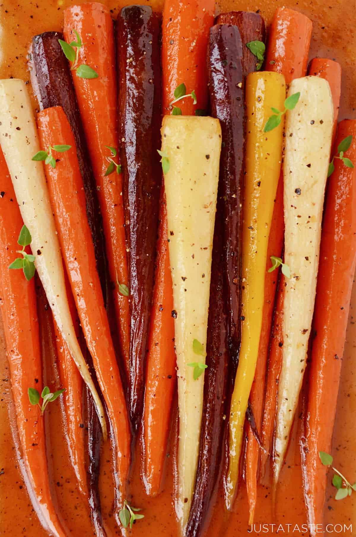 Baked carrots dressed with honey and olive oil and topped with fresh thyme leaves.