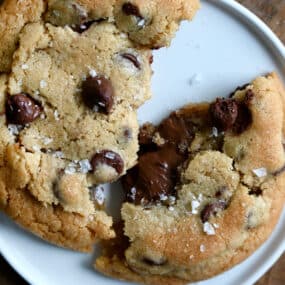 A chocolate chip cookie broken in half with a gooey Nutella filling.