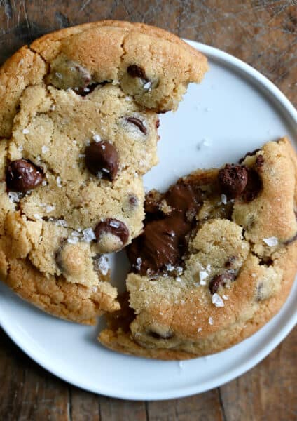 A chocolate chip cookie broken in half with a gooey Nutella filling.