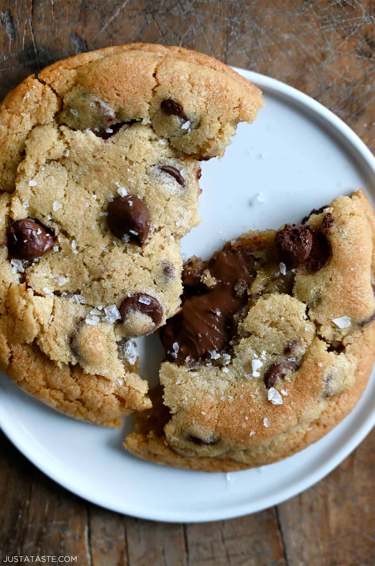 A chocolate chip cookie broken in half with a gooey Nutella filling.