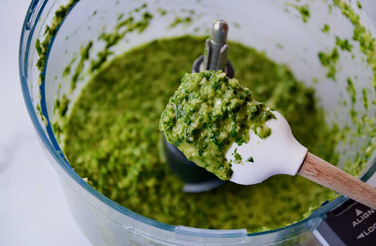 Chimichurri sauce in the bowl of a food processor.