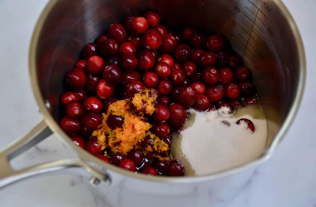 Cranberries, sugar, orange zest and juice, Grand Marnier and water in a stainless steel saucepan.
