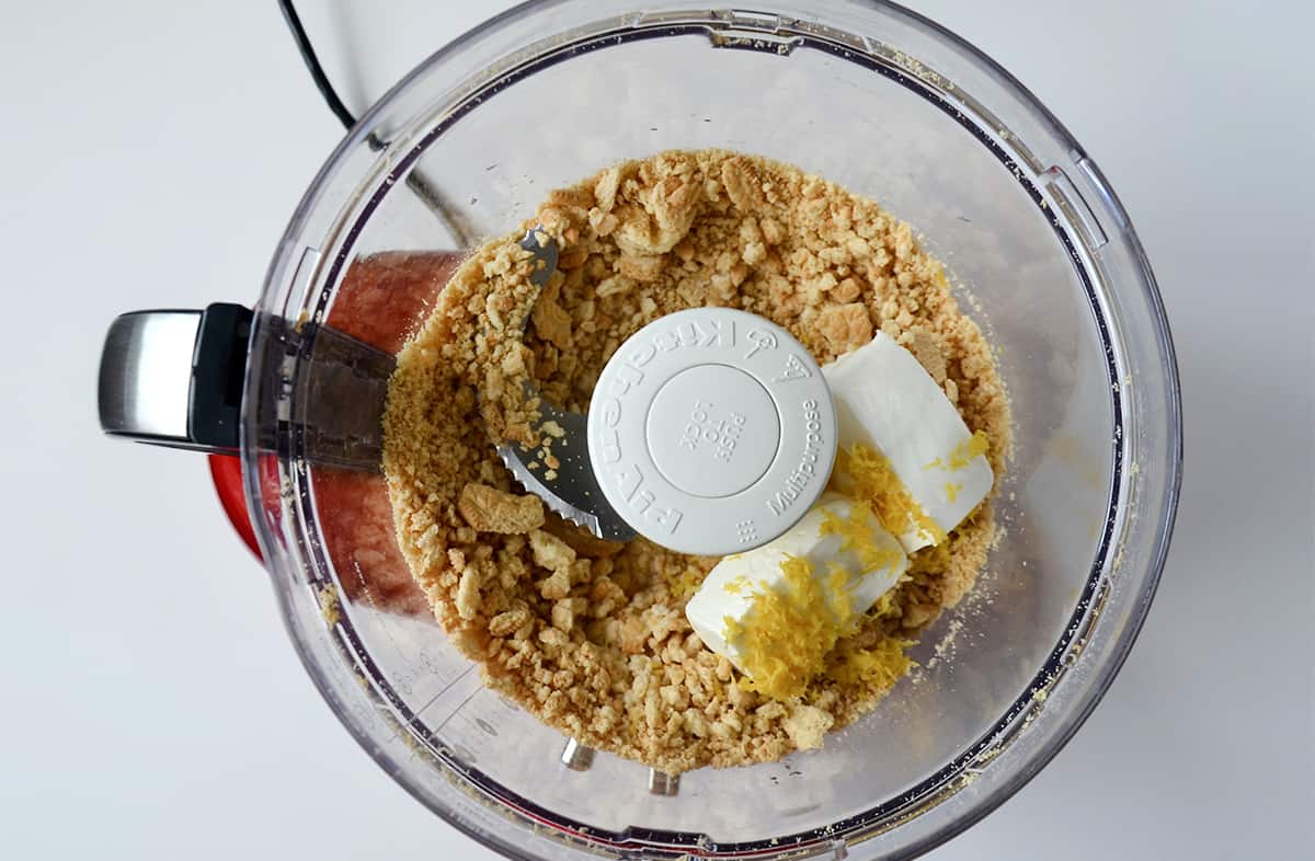 Crushed vanilla cookies, cream cheese and lemon zest in the bowl of a food processor.