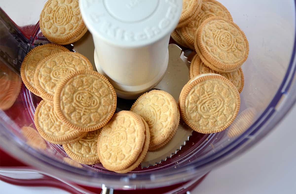 Vanilla sandwich cookies in the bowl of a food processor.