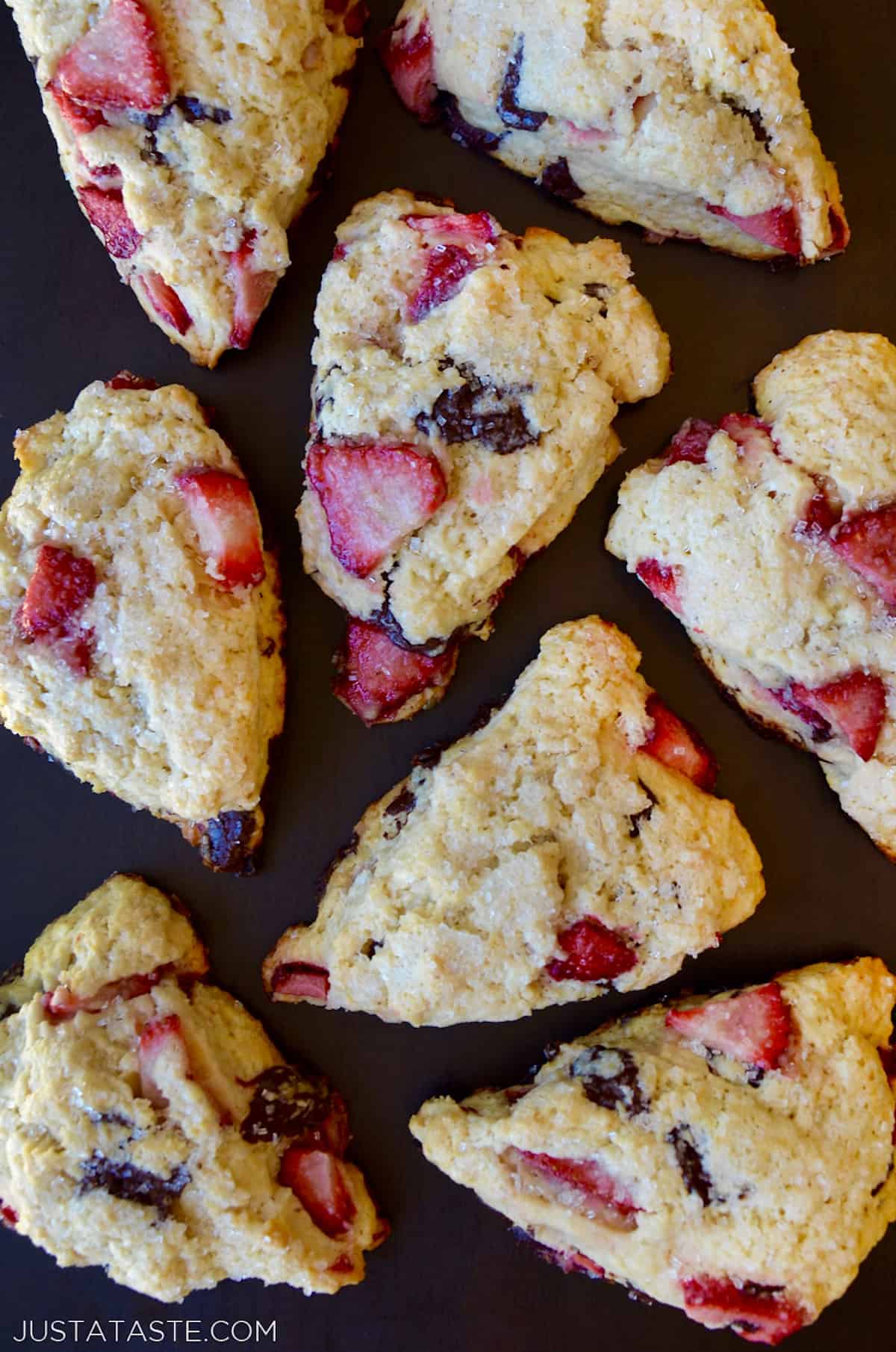 Eight wedges of strawberry chocolate scones.